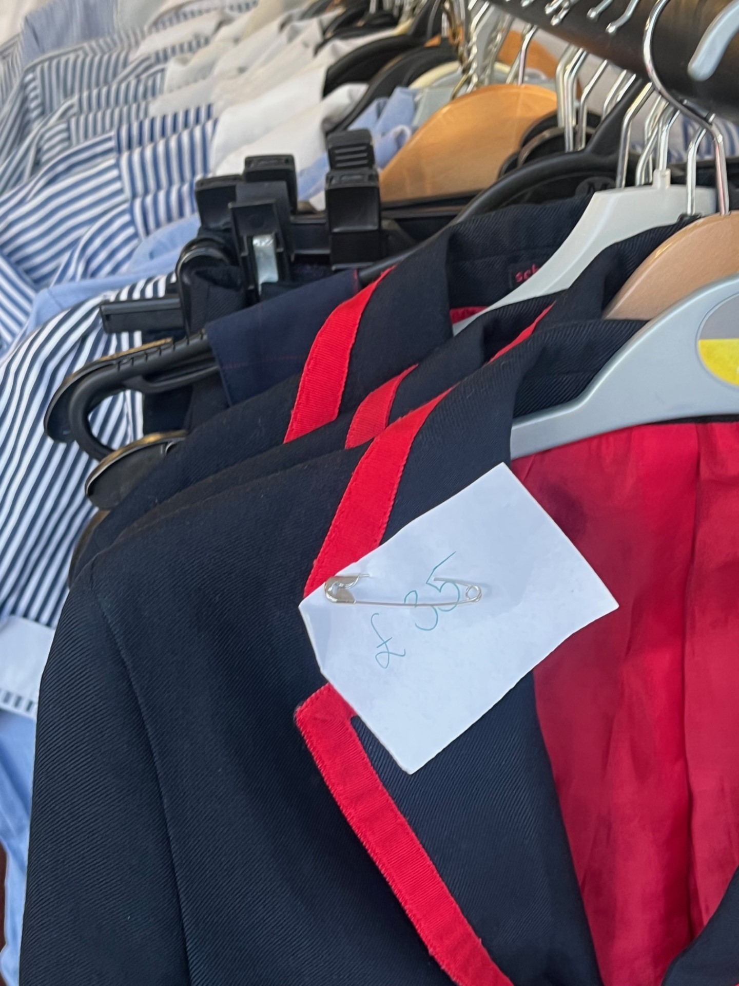 Picture of second-hand uniform hanging on a rail with a price tag pinned on