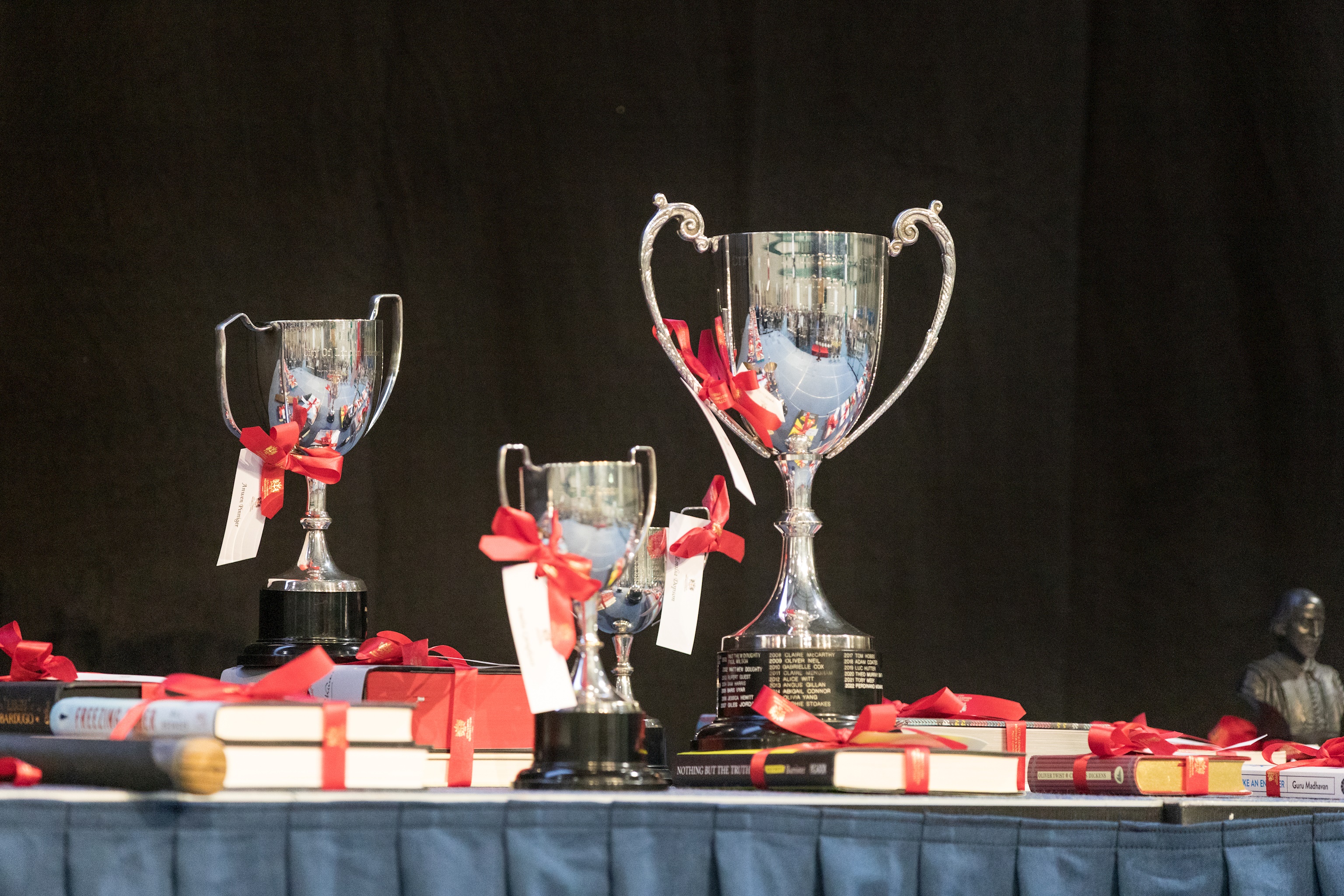 Picture of shiny silver trophies on a table of prizes for Prize Day