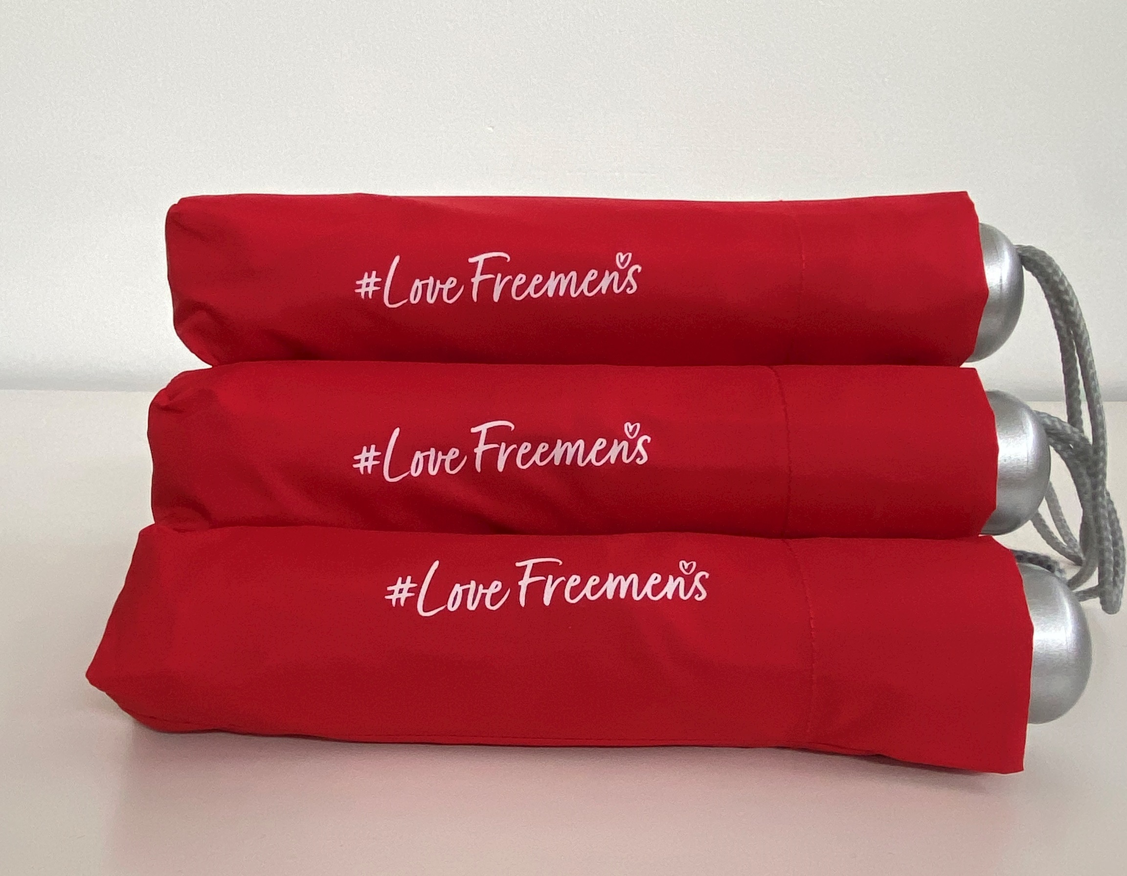 Image of Freemen's merchandise of multiple branded love freemen's umbrellas