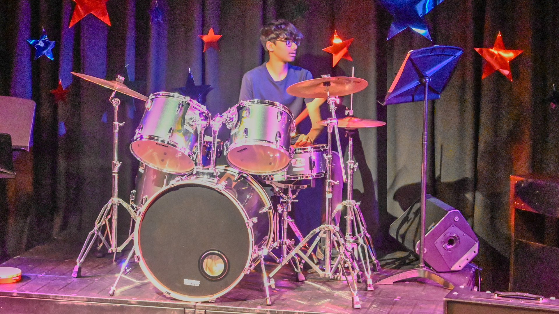 Boy on drums performing on stage at the Freemen's LIVE show