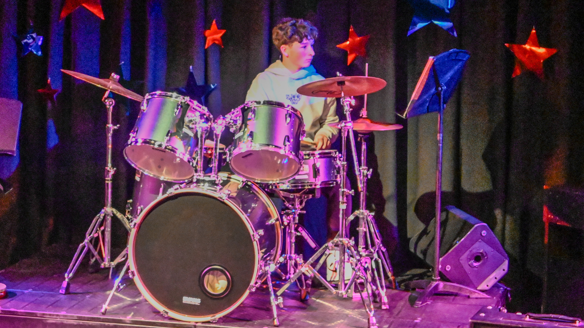 Boy on drums performing on stage at the Freemen's LIVE show